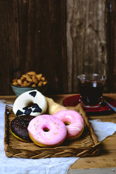 Delicious colorful donuts food on wooden background. - Φωτογραφία, εικόνα