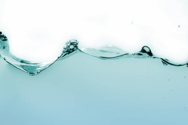 Water splash or water wave with bubbles of air on the background - Foto, immagini