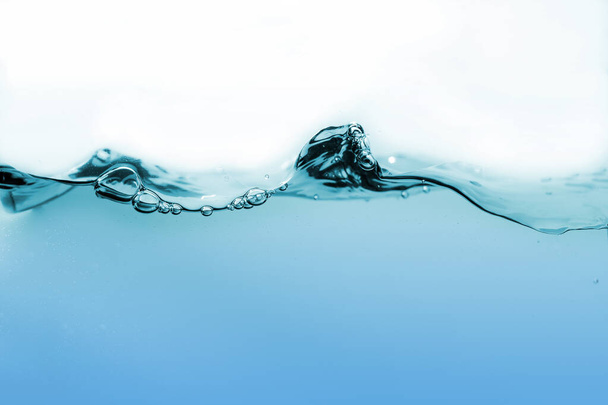Water splash or water wave with bubbles of air on the background - Photo, image