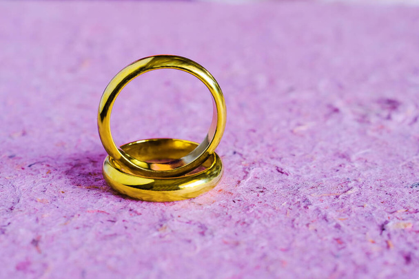 Duo golden wedding ring on paper background.Wedding concept. - Фото, изображение