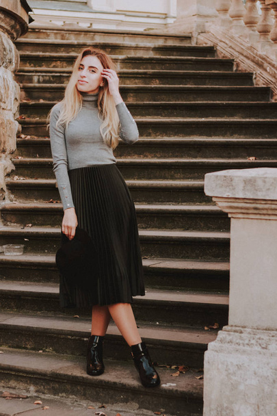 Stylish autumn fashionable image of a girl. Gray blazer, pleats  - 写真・画像
