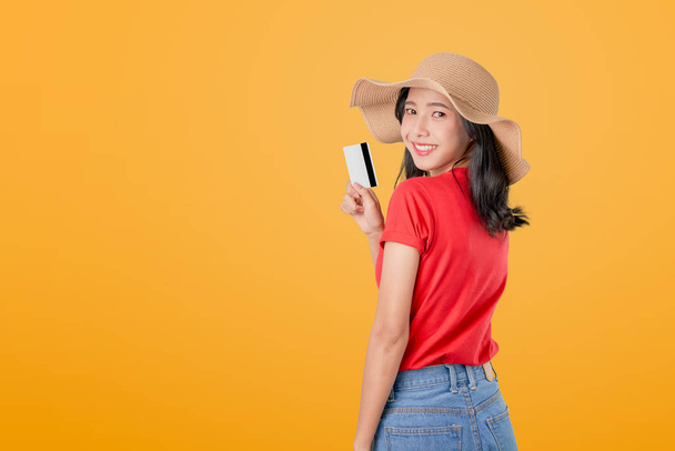 Beautiful Asian woman good skin holding credit card payment on orange background with copy space. - Photo, Image