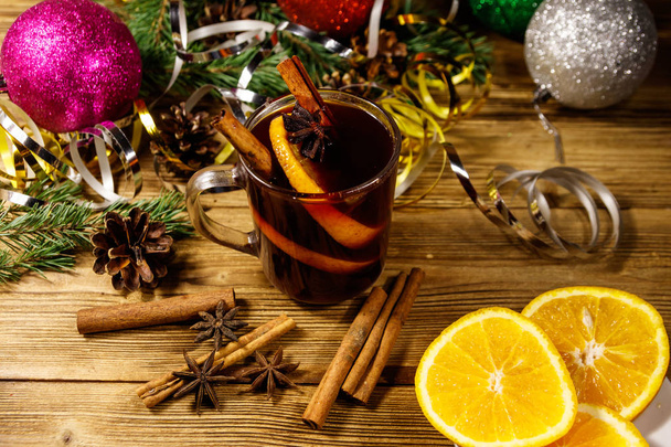 Christmas mulled wine with spices and Christmas decoration on wooden table - Zdjęcie, obraz