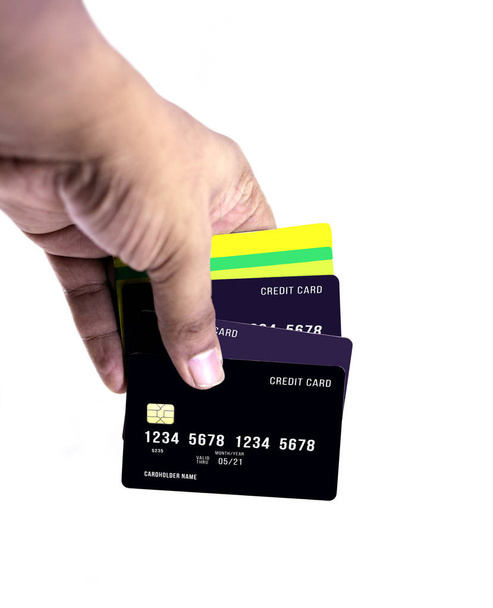 Κράτημα χεριού πιστωτικές κάρτες ή χρεωστικές κάρτες που απομονώνονται σε λευκό φόντο - Φωτογραφία, εικόνα