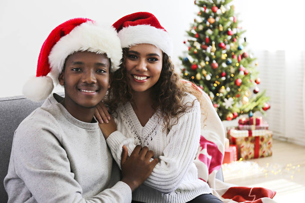 Couple of young people celebrating christmas in themed clothing. - Fotó, kép