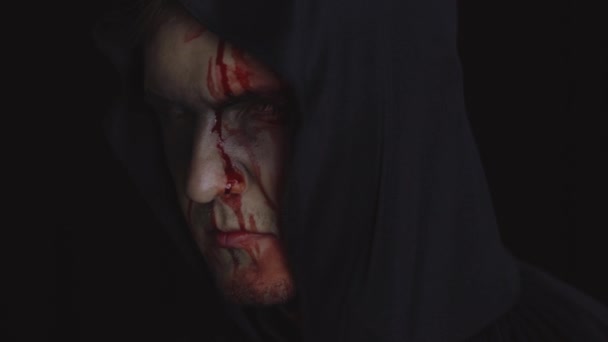 Man executioner Halloween makeup and costume. Guy with blood on his face - Footage, Video
