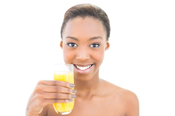Smiling natural beauty holding glass of orange juice - Photo, Image