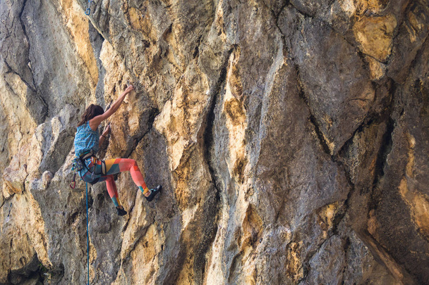 A girl climbs a rock. - Photo, Image