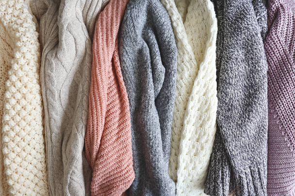 Pile of knitted sweaters of different colors and patterns perfectly stacked. - Zdjęcie, obraz