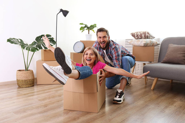 Young married couple moving into a new home. Attractive blonde w - Photo, Image