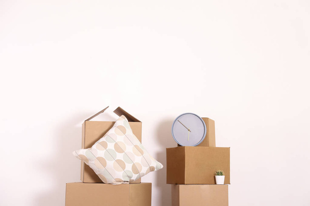 Starting a new life concept. Stacked boxes in minimalistic interior of a new apartment. - 写真・画像