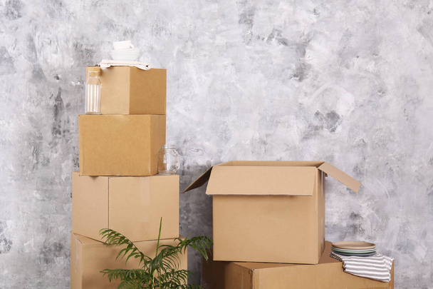 Starting a new life concept. Stacked boxes in minimalistic interior of a new apartment. - Foto, Imagem