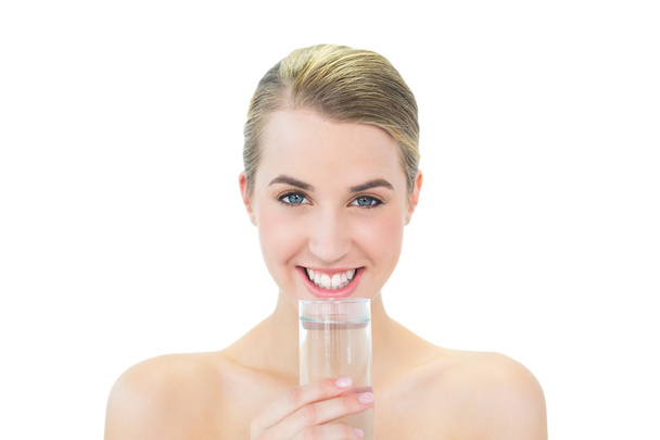 Smiling attractive blonde holding glass of water - Foto, Imagem