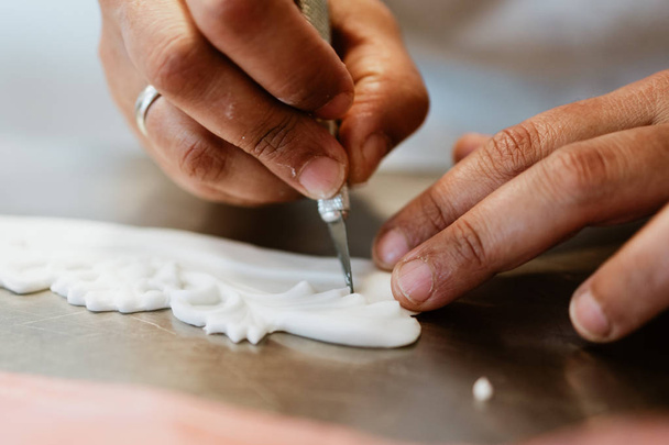 Professional confectioner working making and decorating delicious sweets. Close up shot. - Foto, Imagem