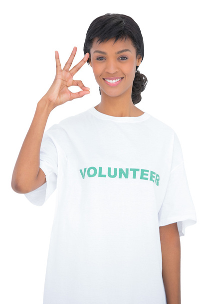 Cheerful black haired volunteer making an okay gesture - Фото, зображення