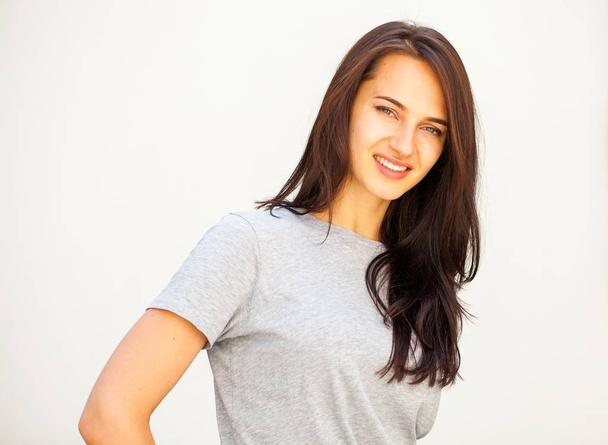 Happy brunette woman in gray t-shirt - Фото, зображення
