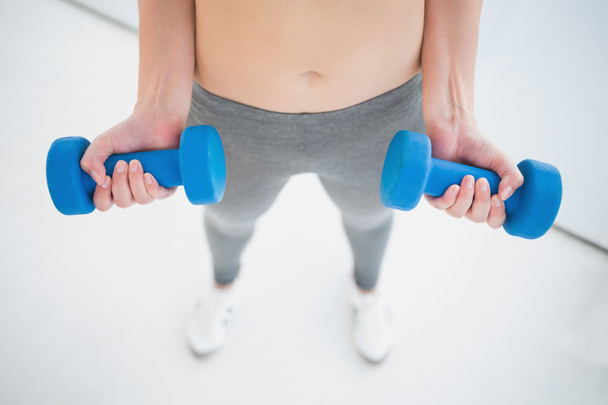 Woman working out with dumbbells - 写真・画像
