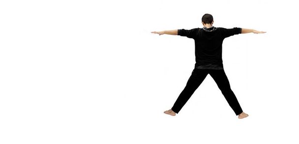 Full-length portrait shot of fit male boy teenager in sportswear and demonstrating Hand stretching exercises isolated on white. Male active pose.Horizontal shot with shadow. - Photo, Image