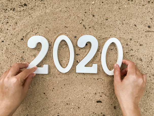 2020 nummers op het zand, gelukkig nieuwjaar - Foto, afbeelding
