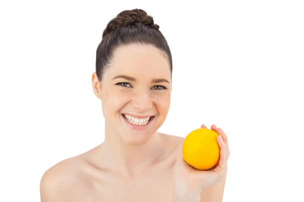 Cheerful pretty model holding orange - Фото, зображення