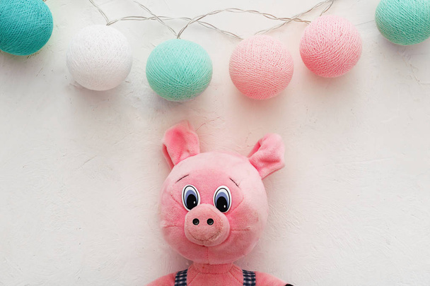 白い背景にピンクの青いボールとおもちゃの子供の豚の庭。新年のコンセプト - 写真・画像