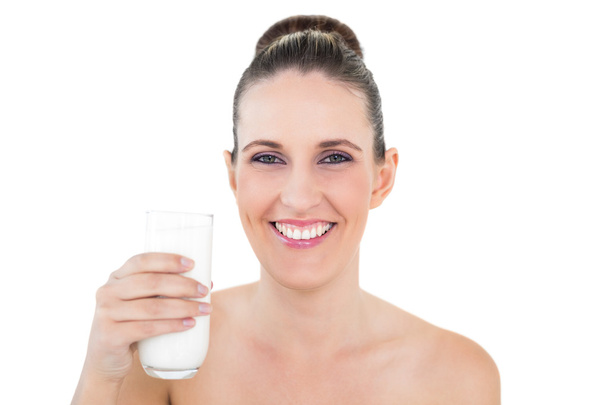 Smiling woman holding glass of milk - Zdjęcie, obraz