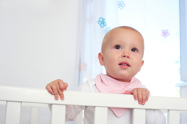 Horizontal portrait of a cute baby in crib - Photo, Image