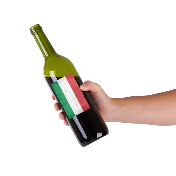 Mano sosteniendo una botella de vino tinto
 - Foto, Imagen