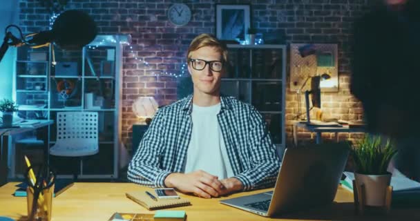 Time lapse of attractive blond guy looking at camera in office late at night - Video