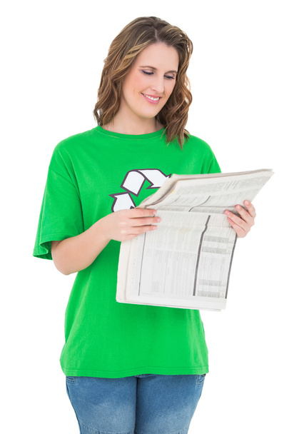 Smiling environmental activist reading newspaper - Foto, Imagen