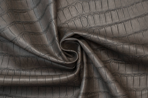 gray crocodile skin artificial leather with waves and folds on PVC base - Foto, afbeelding