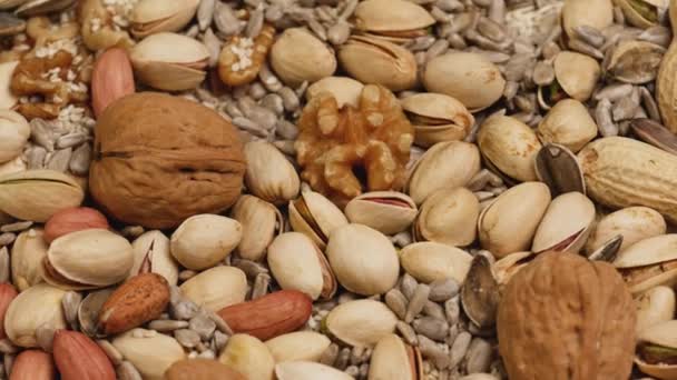 Mix of seeds and nuts: sunflower, walnuts, peanuts, pistachios, sesame . - Video, Çekim