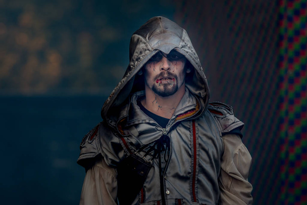 portrait of young man in assassin costume with hood - 写真・画像