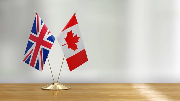 British and Canadian flag pair on a desk over defocused background  - Fotoğraf, Görsel