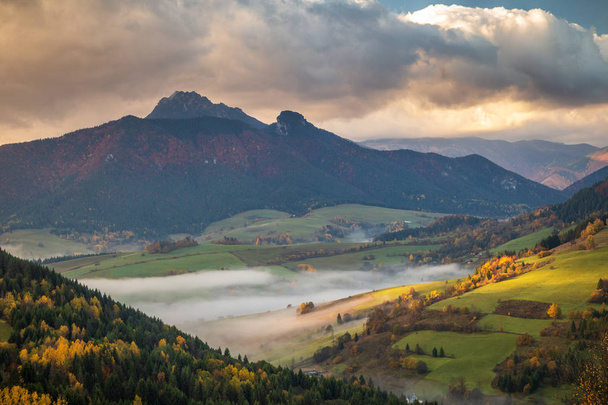 Landscape with mountains at foggy sunrise in autumn. - Photo, Image
