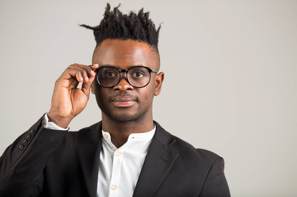 handsome young african man in black suit wearing glasses - Photo, Image