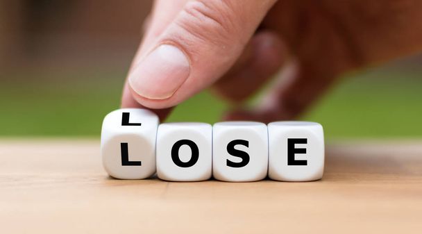 Lose Lose situation. Hand turns dice and changes the word "lose" - Foto, immagini
