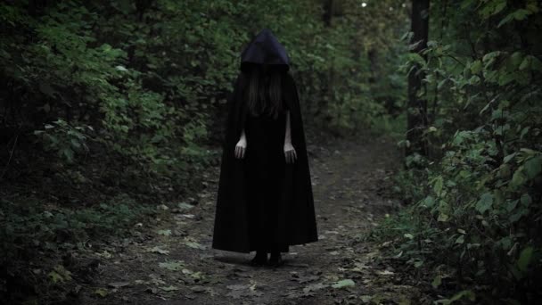 black witch is wearing black coat with hood - Footage, Video