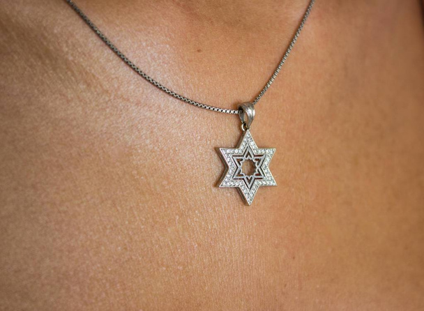 Silver pendant of a David star on the girl's neck - Photo, Image