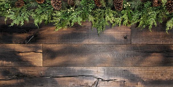 Christmas decoration pine tree branches wooden background - Foto, Imagen