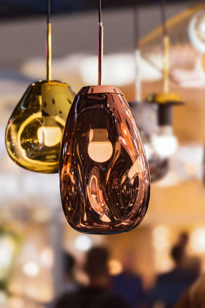 Modern streamlined mirror oval copper chandelier. Bubble metal copper gold shade pendant - Photo, image