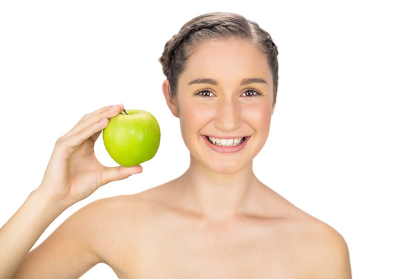 Cheerful healthy model holding green apple - Foto, afbeelding