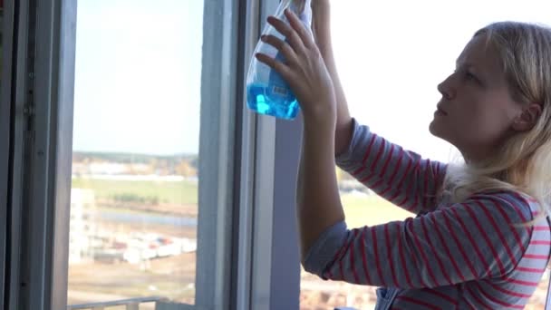fiatal nő tisztítja az ablakot - Felvétel, videó