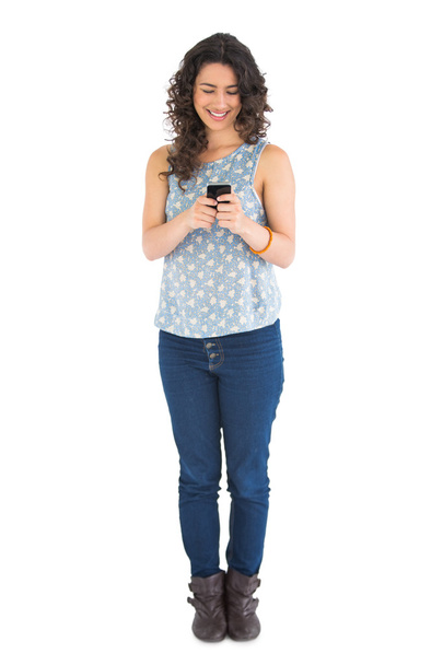 Smiling attractive brunette texting - Valokuva, kuva
