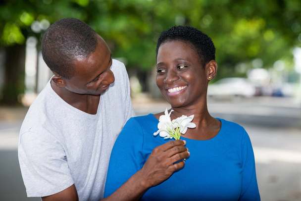 young happy couple with white flowers on the outside - Photo, Image