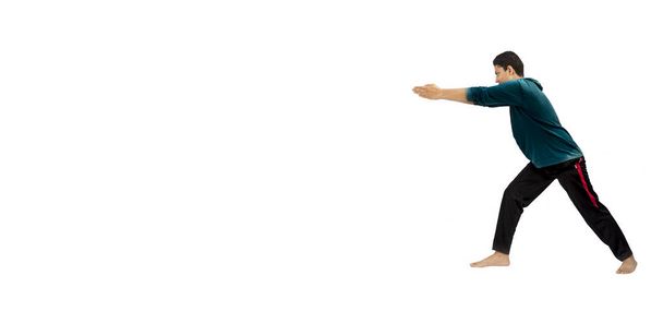  male teenager doing yoga exercise or stretching exercise isolated on white background - Photo, Image