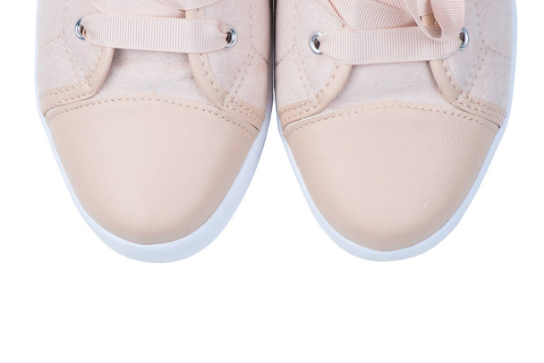 Women's pink canvas sneakers with beads close-up toe on a white  - Photo, Image