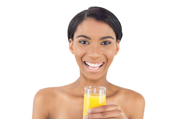 Smiling attractive model holding glass of orange juice - Foto, immagini