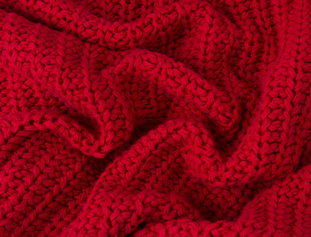 Textur aus rotem Strickstoff in Nahaufnahme. Strickwaren aus Wolle - Foto, Bild