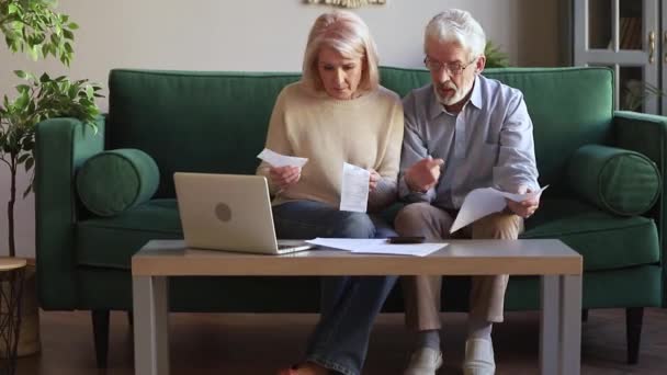 Elderly couple managing family budget checking expenses feels anxious - Imágenes, Vídeo